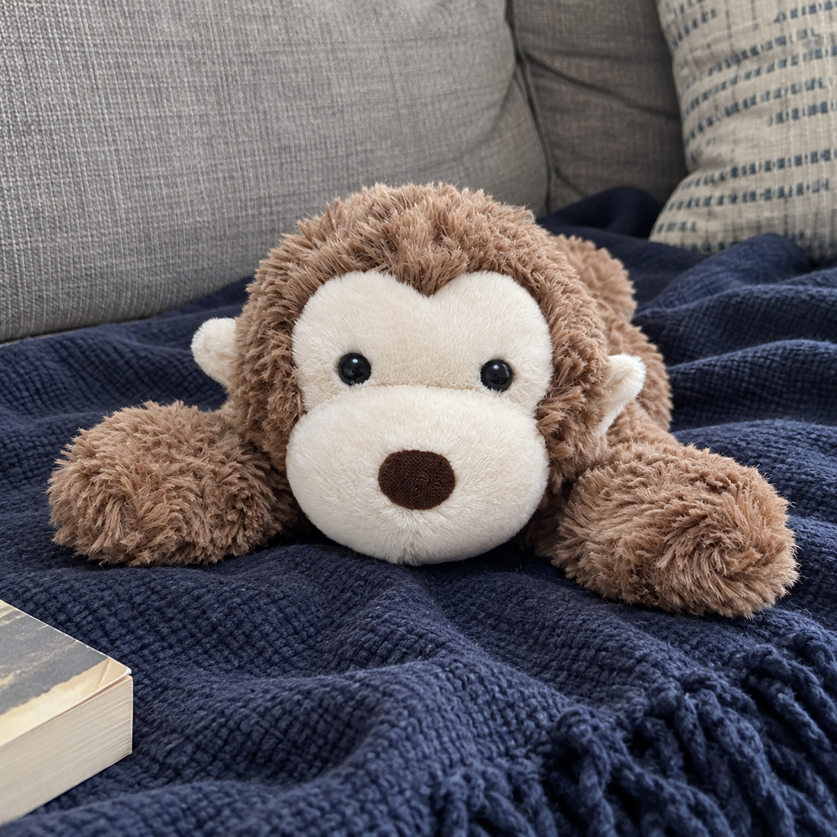 Jimny Monkey plush in an everyday sofa setting